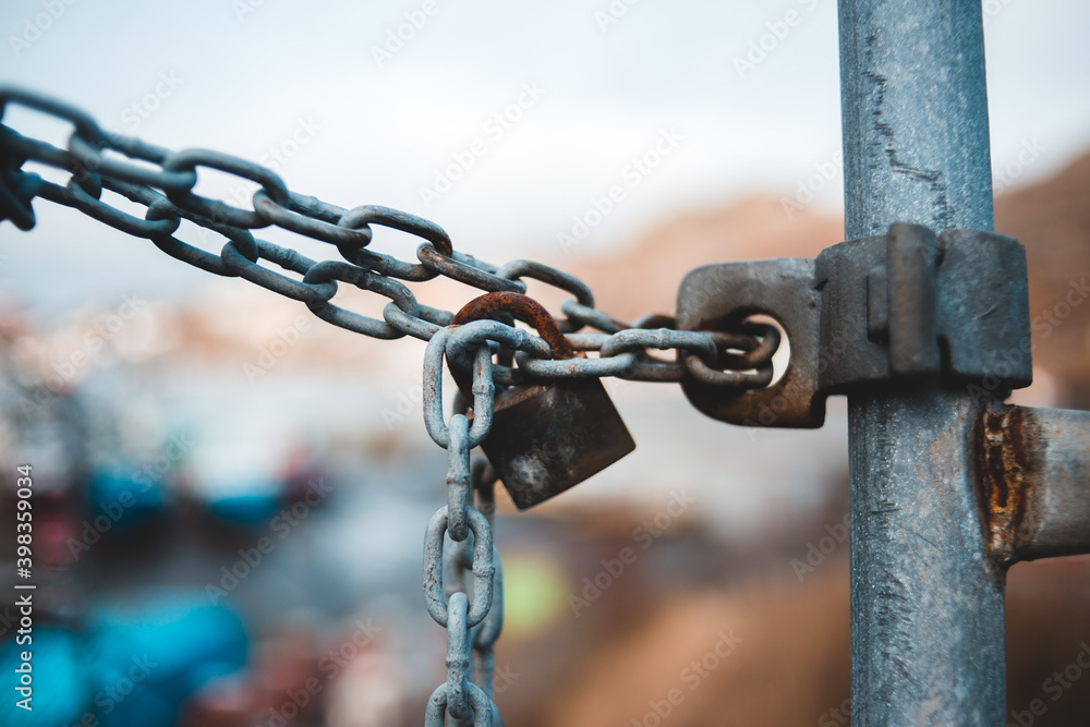 padlock and chain on a fence gate padlock and chain on a fence gate