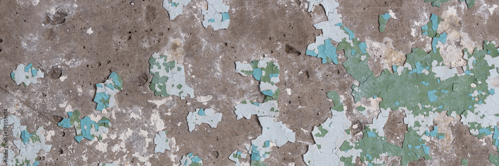 Naklejka premium Peeling paint on the wall. Panorama of a concrete wall with old cracked flaking paint. Weathered rough painted surface with patterns of cracks and peeling. Wide panoramic texture for grunge background