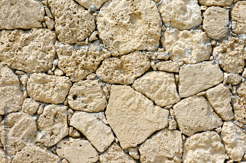 Texture of an old stone wall. Well seen pattern.