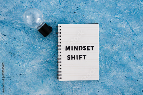 positivity and law of attraction, notepad with Mindset Shift text with light bulb next to it
