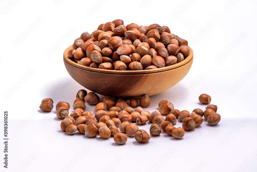 Hazelnuts in a wooden bowl on white background. Solid ripe Hazelnuts
Hazelnuts in a wooden bowl on white background. Solid ripe Hazelnuts