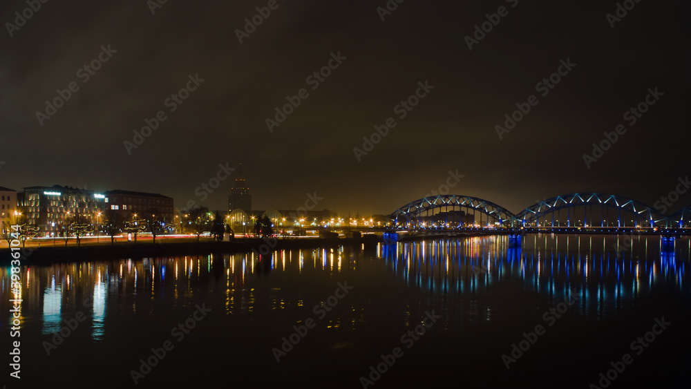 Obraz premium Riga,Latvia,Europe, night views of the city and the railway bridge
