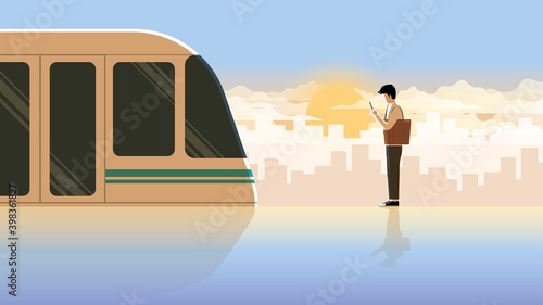Alone office man first jobber use smartphone waiting in public transportation station for the first train at the early morning sunrise. Active lifestyle of diligent and on time employee salaryman.