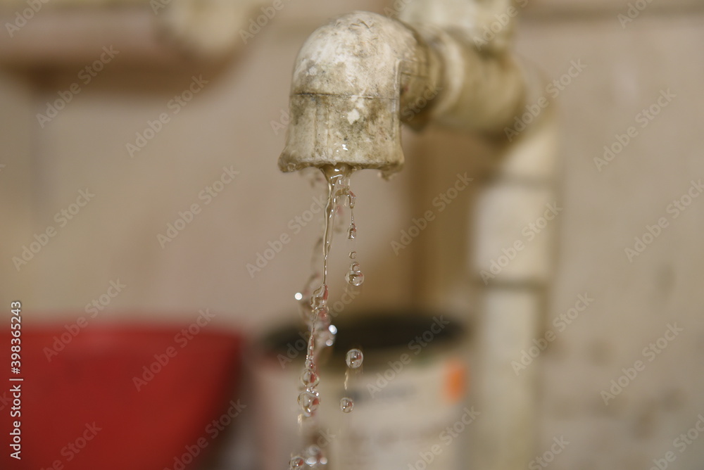 Plastic dirty faucet with water falling drops