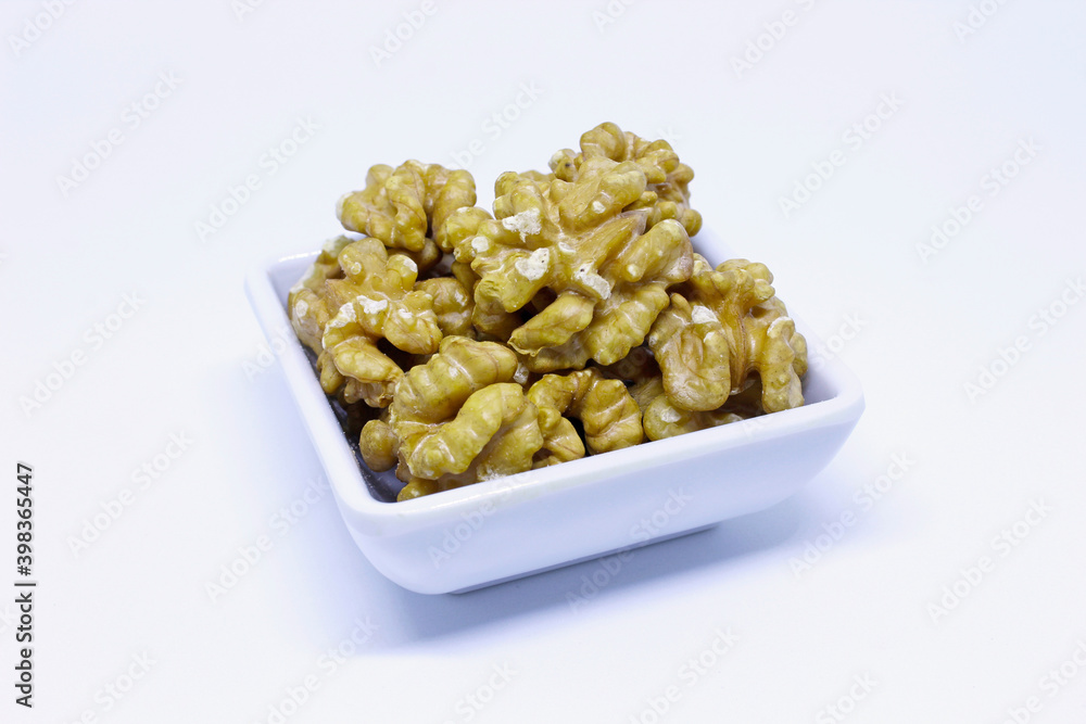Portion of fresh walnuts isolated on white background Portion of fresh walnuts isolated on white background