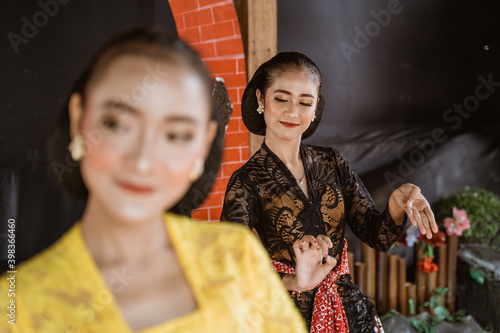 portrait expression young women performing traditional Javanese dancing photo