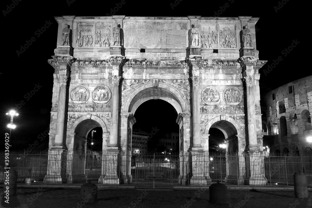 The monuments of rome in black and white at night.	