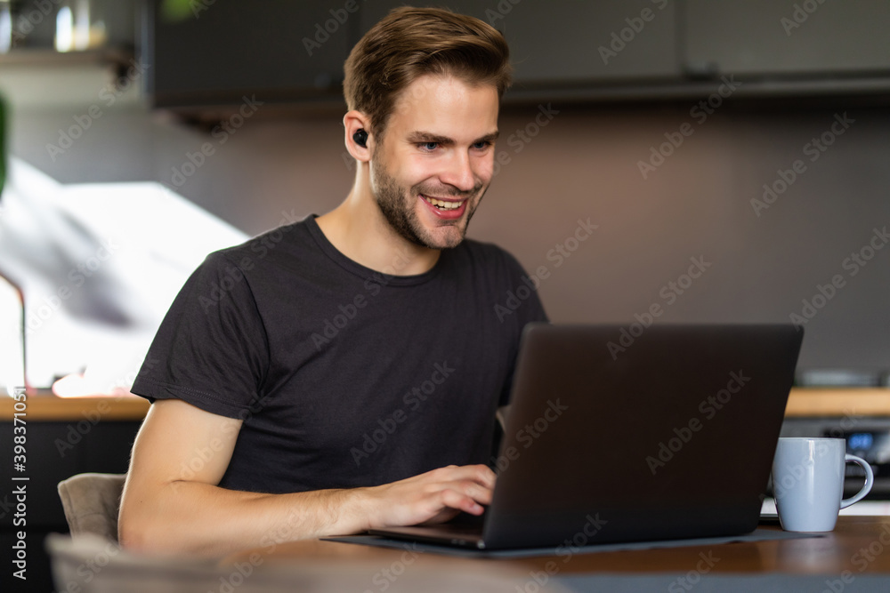 Young handsome man sit and use laptop work in the morning Young handsome man sit and use laptop work in the morning