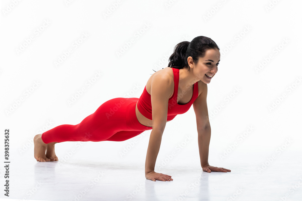 Young woman working out her body by doing plank isolated on white background Young woman working out her body by doing plank isolated on white background