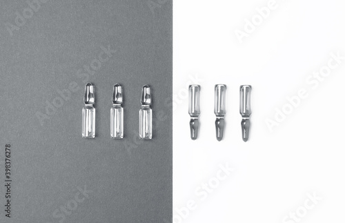 Line of ampules for injections on trendy grey and isolated white background. Medicine  healthcare and pharmacy concept. Color 2021 concept. Flat lay style.