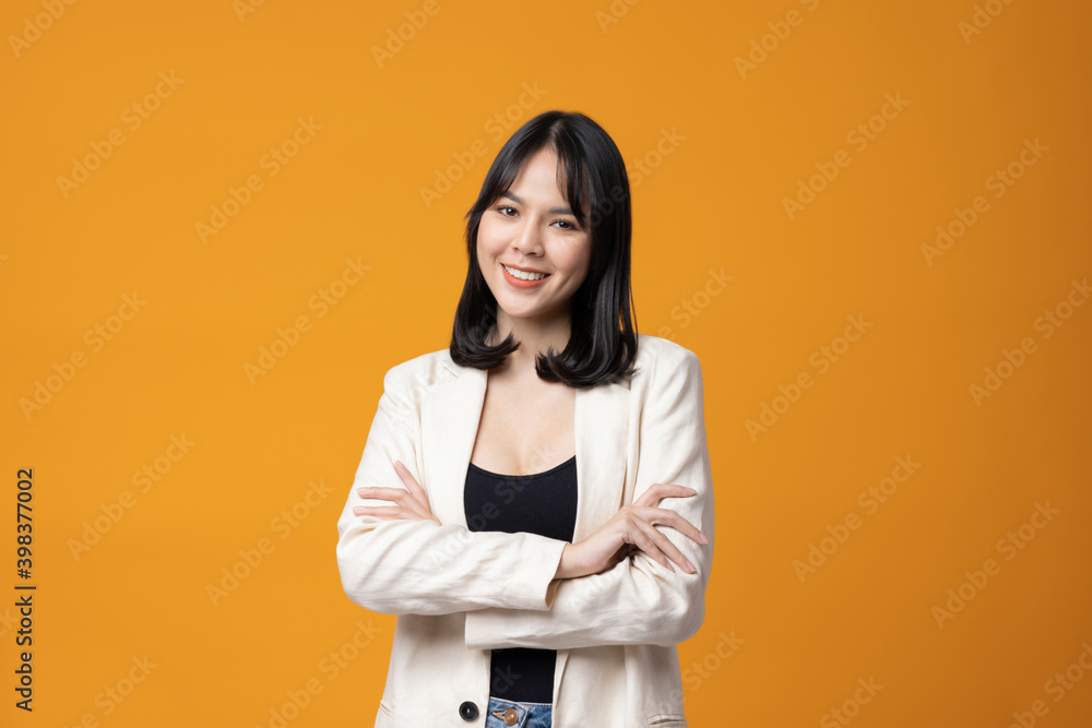 Attractive Beautiful asian woman standing and posing. Sexy female in suit on isolated yellow background. Attractive Beautiful asian woman standing and posing. Sexy female in suit on isolated yellow background.