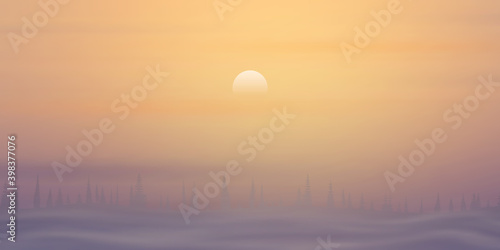 Minimalistic winter landscape. The sun is setting, a forest on the horizon and fog.