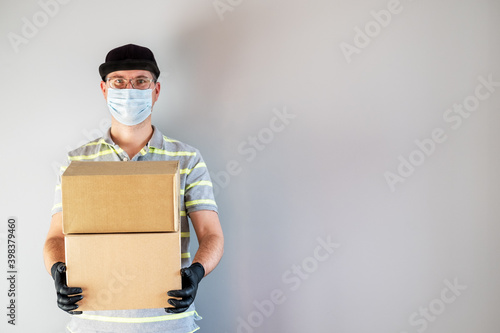 Delivery service man holding carton boxes.