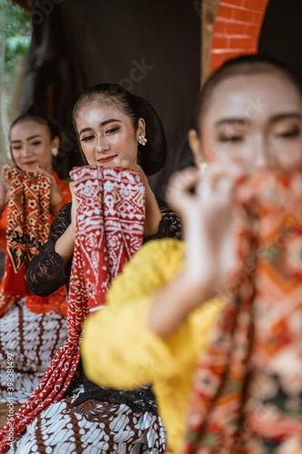 portrait of three young women presenting traditional Javanese dance movements