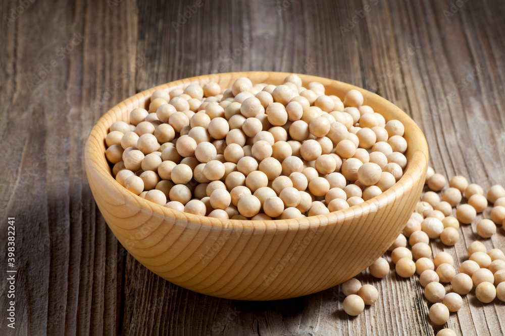 Soybean seeds in a wooden bowl on old wood. Soybean seeds in a wooden bowl on old wood.