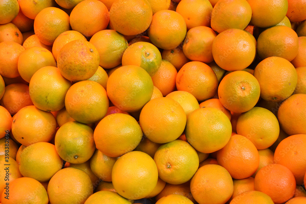 groups of fresh oranges in the stall for sale in the market
