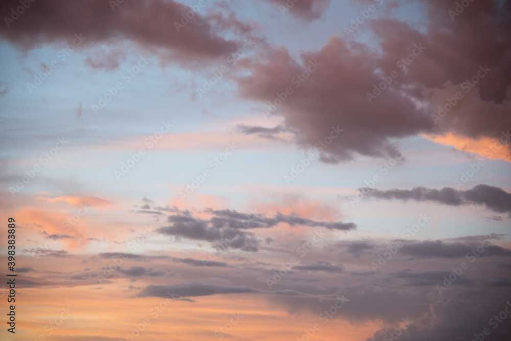 Naklejka premium Beautiful sky background. Light blue sky with dramatic orange, pink and gray clouds. Perfect for sky replacement. High quality photo