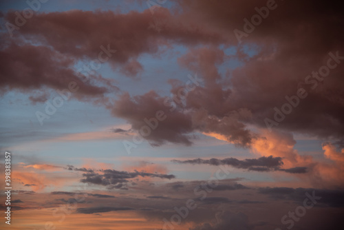 Beautiful sky background. Light blue sky with dramatic orange, pink and gray clouds. Perfect for sky replacement. High quality photo