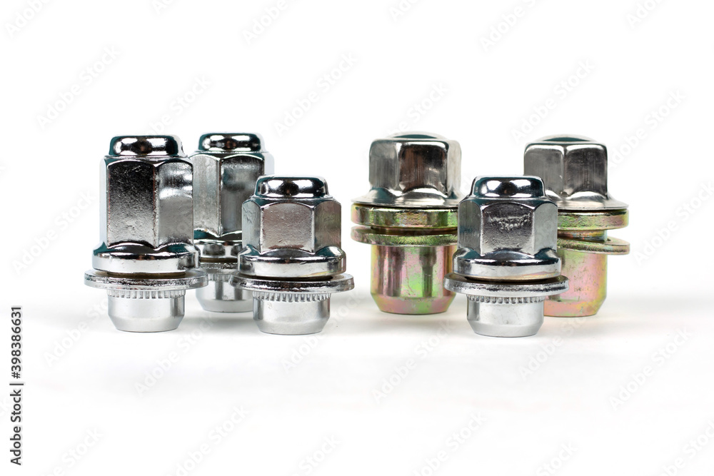 several shiny wheel nuts on a white background several shiny wheel nuts on a white background
