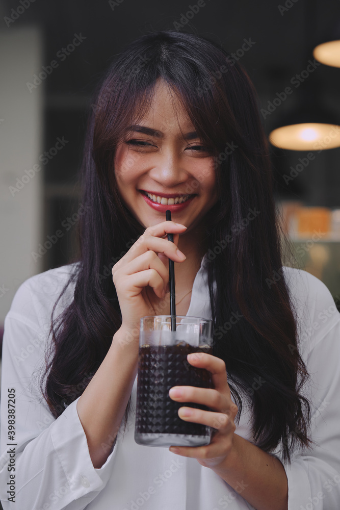 happy asian young woman drinking iced coffee