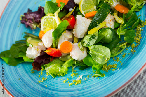 Recipe of salad with pickled codfish: chop 200gr of cod fillets, marinate in lemon juice and black pepper. Serve with lettuce leaves, fresh carrots and lemon slices. Season with oil and balsamic photo