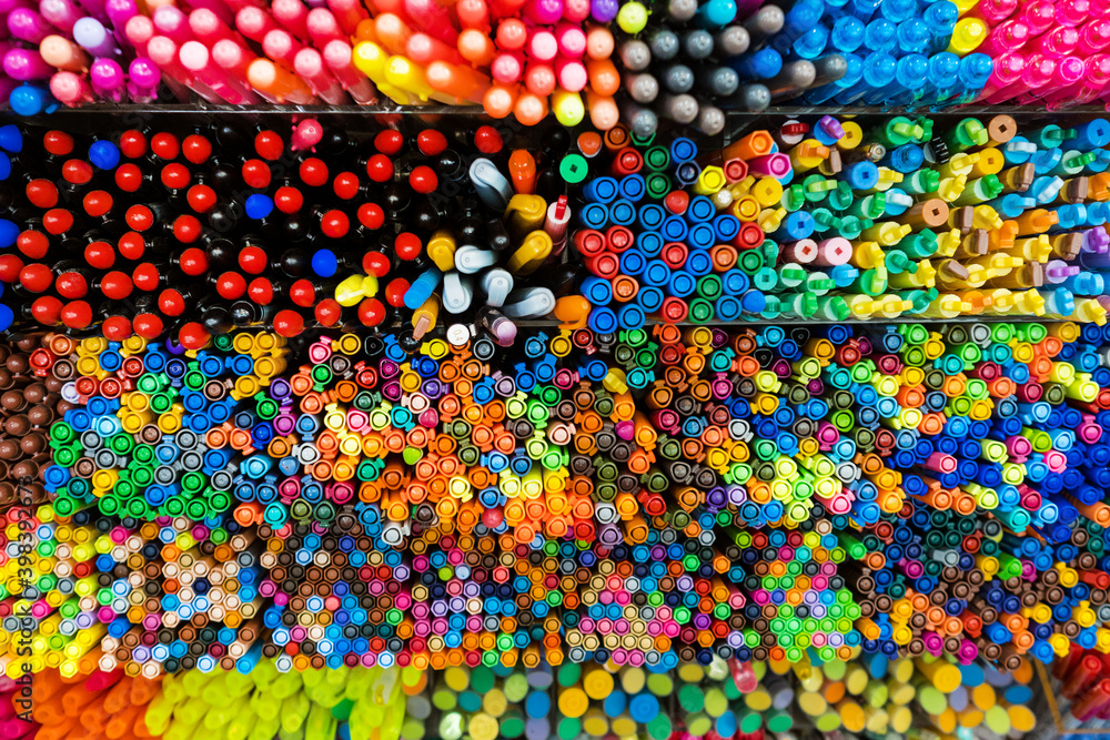 Top view of mixed colorful markers placed in the box. Pattern and texture. Background. Stationery.