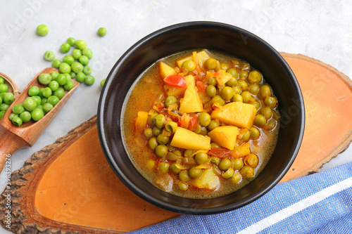 Indian popular homemade Aloo Matar. Potatoes and peas curry. Vatana batata bhaji or sabzi. with cooking ingredients along with copy space.