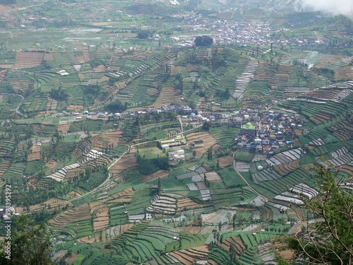 Wonosobo, Indonesia, June 11, 2016. The Dieng plateau ruralscape seen from a height. The green landscape of agricultural land dominates among a number of residents' houses