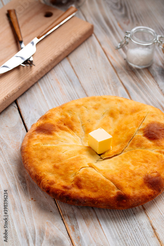 Georgian cuisine megrelian khachapuri bread on the wooden table photo