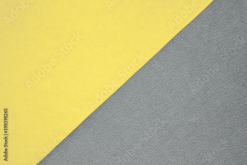 Textured and plain paper sheets divided diagonally creating line partition. Trendy pastel colored yellow and neutral gray abstract duo tone background design. Year color concept  photo