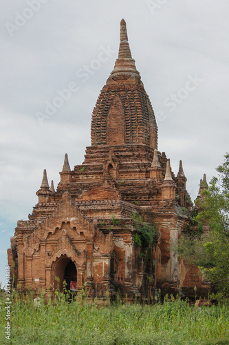 a large brick castle with Dhammayangyi Temple in the background