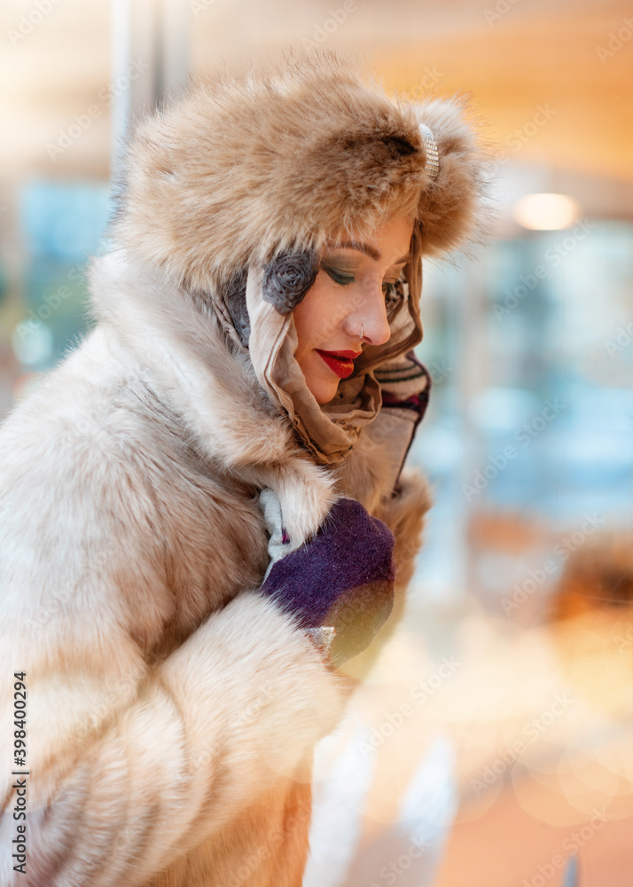 a woman in winter clothes looking at window and shopping a woman in winter clothes looking at window and shopping