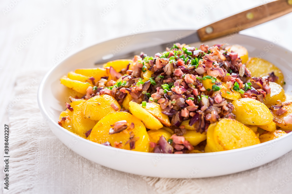 German fries - fried potatoes with bacon and onion topping German fries - fried potatoes with bacon and onion topping