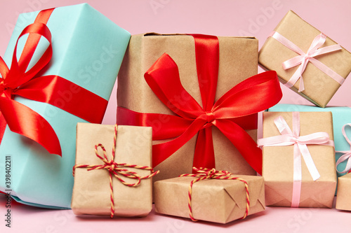 Christmas or New Year gift boxes against a pink background. Close-up, selective focus