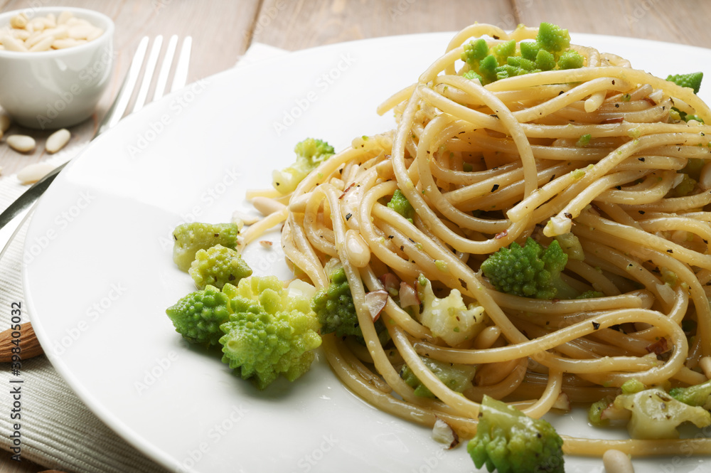 Pasta. Spaghetti with broccoli, almonds, pine nuts, oregano and extra virgin olive oil, closeup. Pasta. Spaghetti with broccoli, almonds, pine nuts, oregano and extra virgin olive oil, closeup.