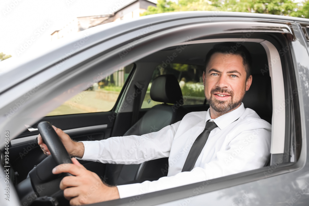 Successful businessman driving modern car