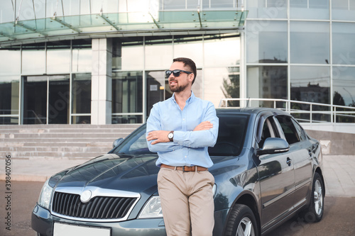 Handsome man near modern car