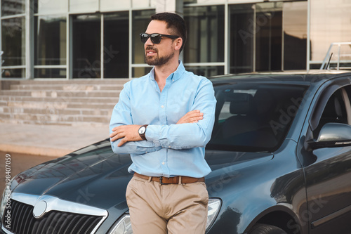 Handsome man near modern car