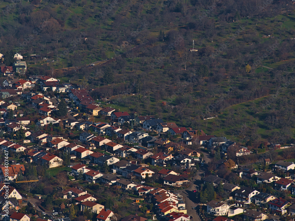 Aerial view of residential area with single- and two-family houses on the edge of village Owen, Baden-Wuerttemberg, Germany located on the foothills of Swabian Alb with meadow orchards on hill.
