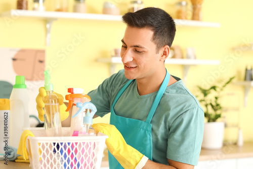 Smiling young man in apron ...