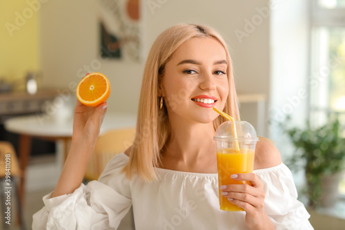 Beautiful young woman drink...