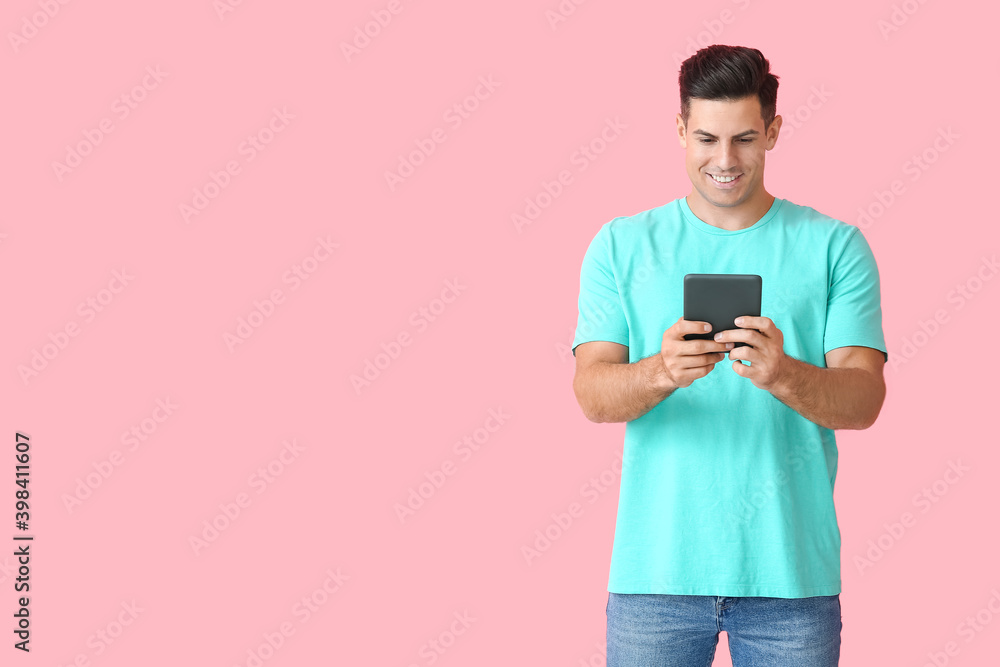 Young man with e-reader on color background Young man with e-reader on color background