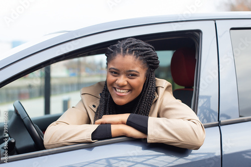 Happy girl in a car driving, African American