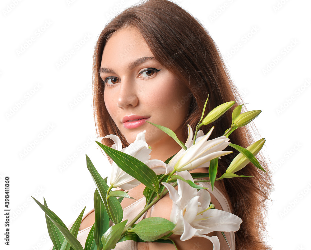 Naklejka premium Beautiful young woman with fresh lilies on white background