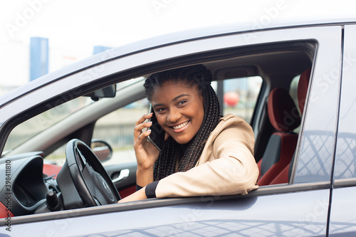 Happy girl driving a car with a phone, African-American © vilma3000
