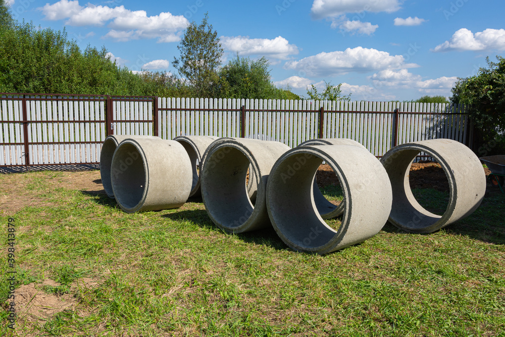 well rings made of reinforced concrete lie on the grass well rings made of reinforced concrete lie on the grass