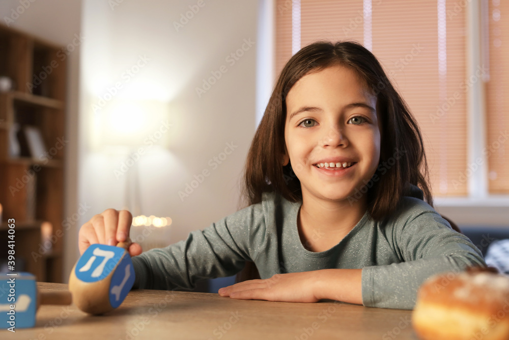 Happy little girl celebrating Hannukah at home Happy little girl celebrating Hannukah at home