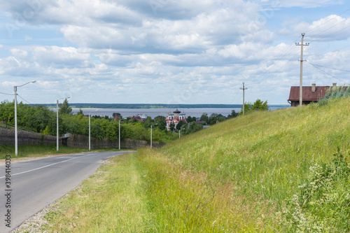 Kozmodemyansk, view of the Smolensk Cathedral and the wide Volga river, photo was taken on a sunny summer day photo