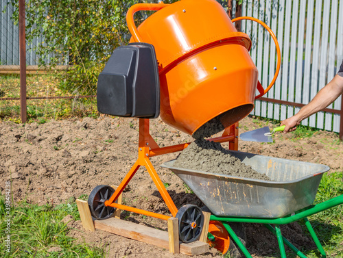 ready-mixed concrete discharged into a cart from a 200 liter electric concrete mixer