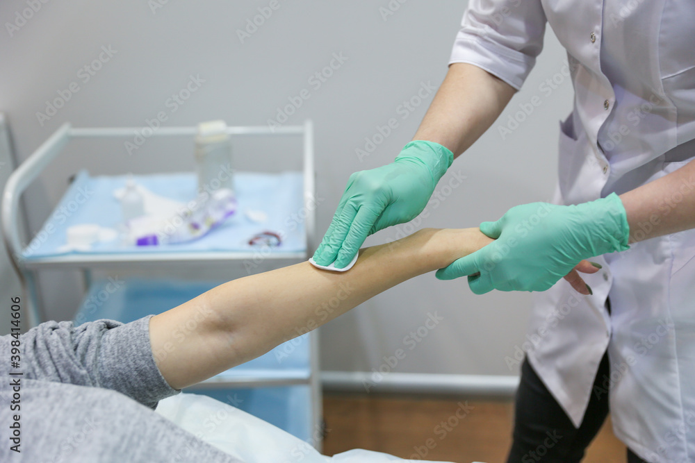 Obraz premium waxing procedure in the beautician's office. woman's hand epilation with wax strip